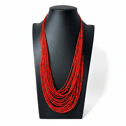 Sahara multi-strand layered beaded necklace in black, red, and gold.