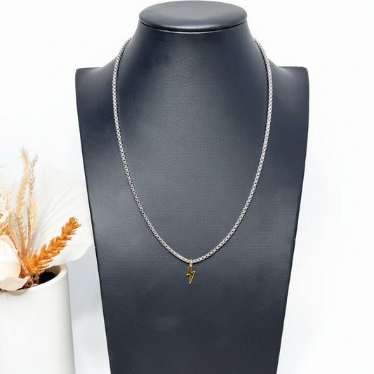 Ray of Power — a sleek silver stainless steel chain necklace accented with a striking gold pendant, elegantly showcased on a mannequin for a sophisticated, timeless look.