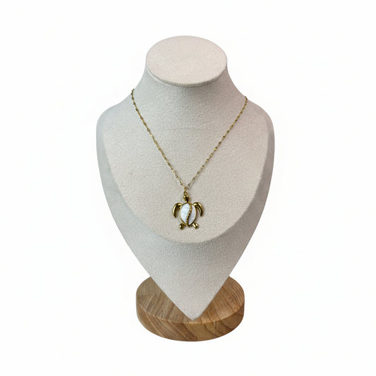 A gold-colored conch shell necklace made of stainless steel, displayed on a white mannequin.