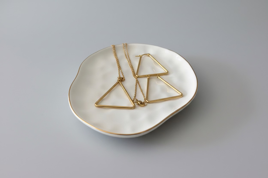 Lustrous Geometry gold titanium triangle necklace and matching earrings set.