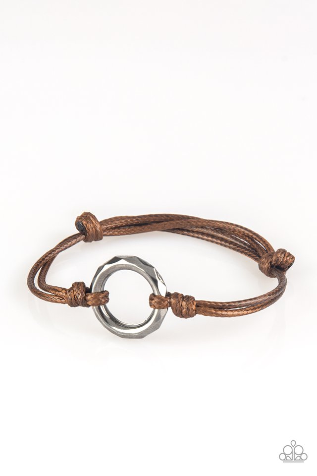 Urban Outsider Brown Urban Bracelet. Shiny brown cording knots around a faceted gunmetal hoop, creating an edgy urban centerpiece atop the wrist. Features an adjustable sliding knot closure. Sold as one individual bracelet.