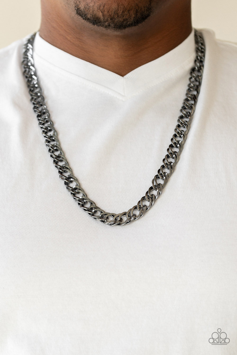 Featuring doubled links, a glistening gunmetal chain drapes across the chest for a bold look. Features an adjustable clasp closure. Sold as one individual necklace.