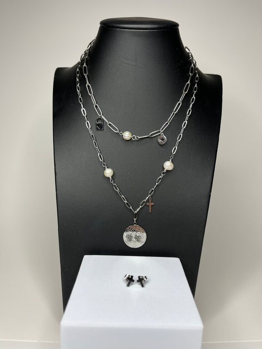 A set of jewelry displayed on a mannequin including layered necklaces with gold and silver colors, pearl details, heart and cross charms, and a pair of earrings.