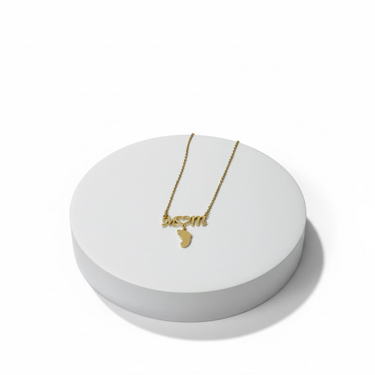 Gold stainless steel Mom script pendant necklace with baby foot charm.