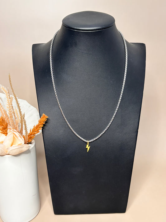 Ray of Power silver stainless steel chain necklace featuring a gold pendant, elegantly displayed on a mannequin.