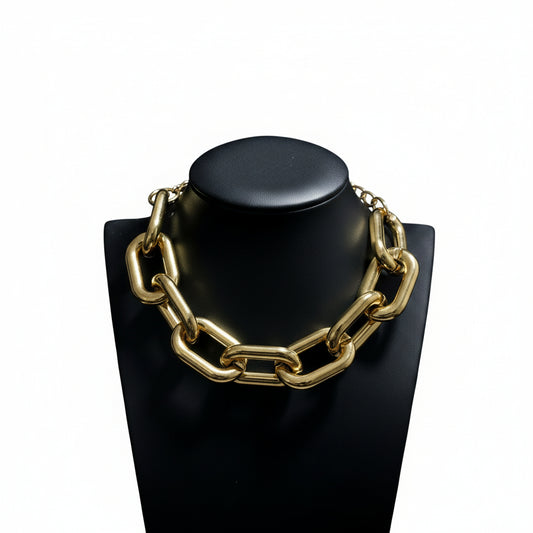 Power irregular chunky link metallic choker necklace in gold and silver displayed on a pedestal mannequin.