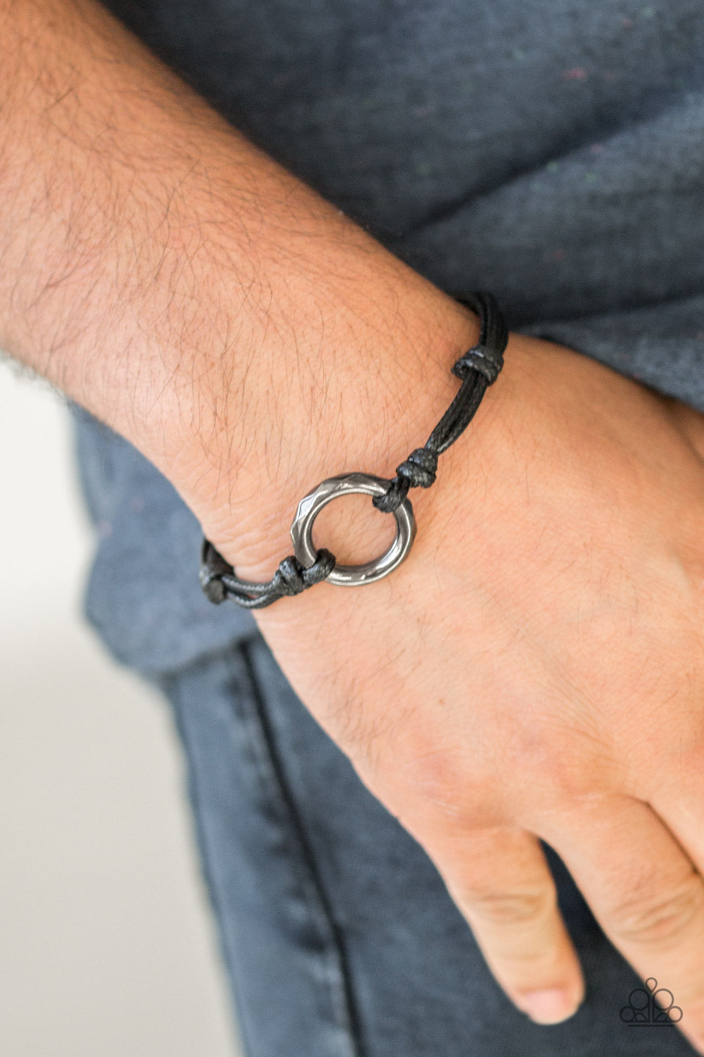Urban Outsider Urban Bracelet.  Shiny brown cording knots around a faceted gunmetal hoop, creating an edgy urban centerpiece atop the wrist. Features an adjustable sliding knot closure.  Sold as one individual bracelet.